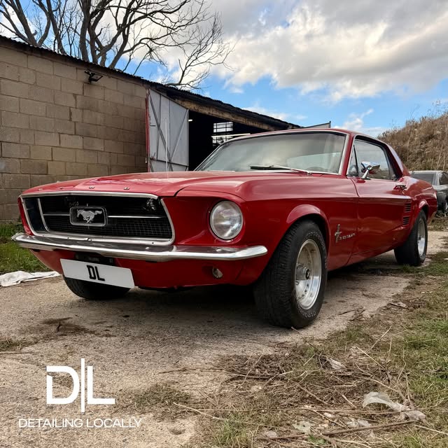 Red classic Ford Mustang after a detail